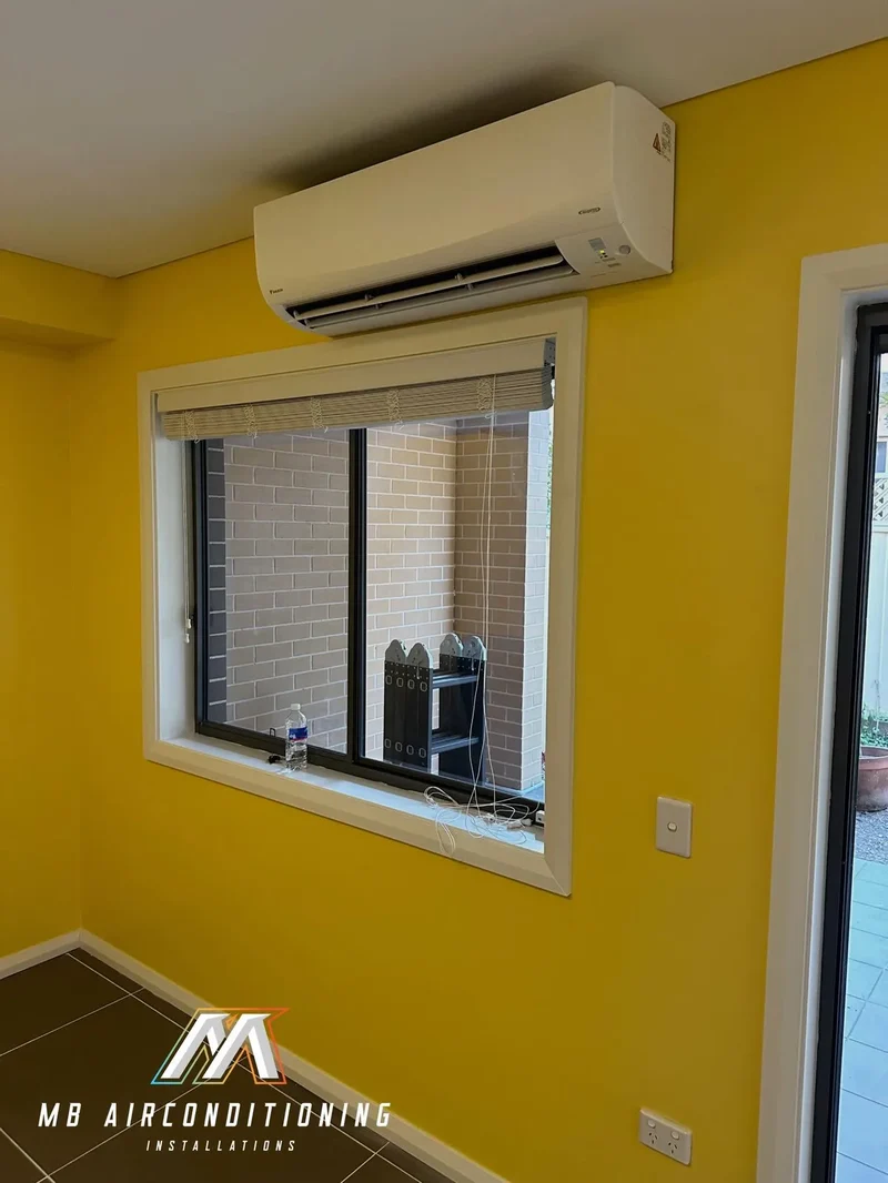 Split system installed above a window in a bright family room