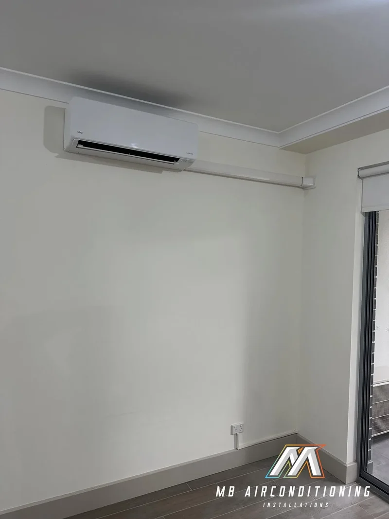 Reverse cycle split system fitted to a lounge room wall