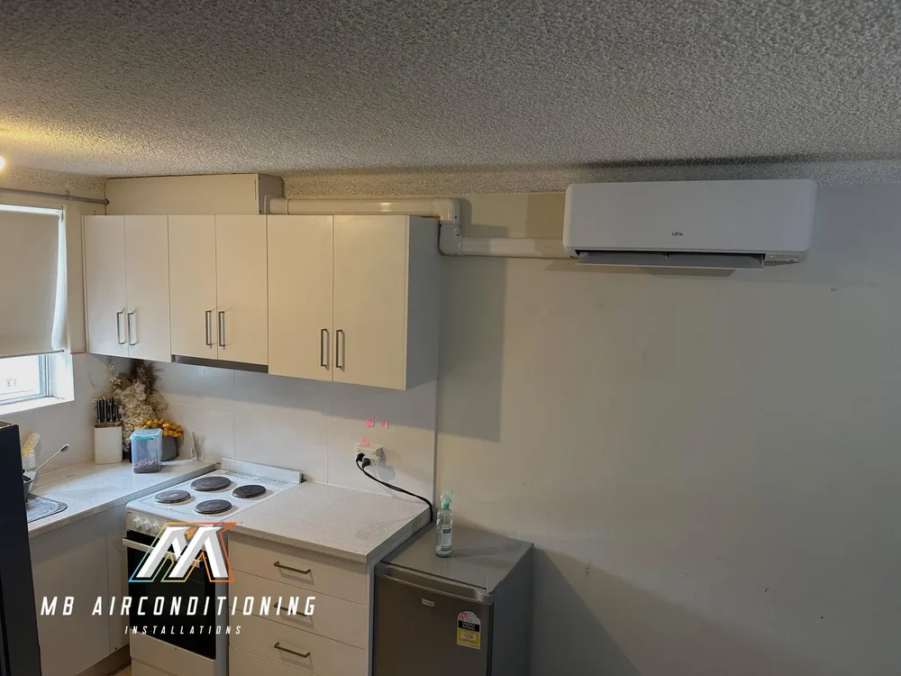 Split system air conditioner installed in an open plan kitchen and living area