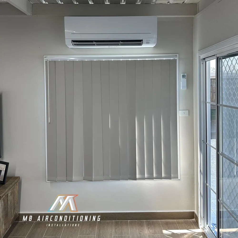 Split system air conditioner installed above a window in a Western Sydney home